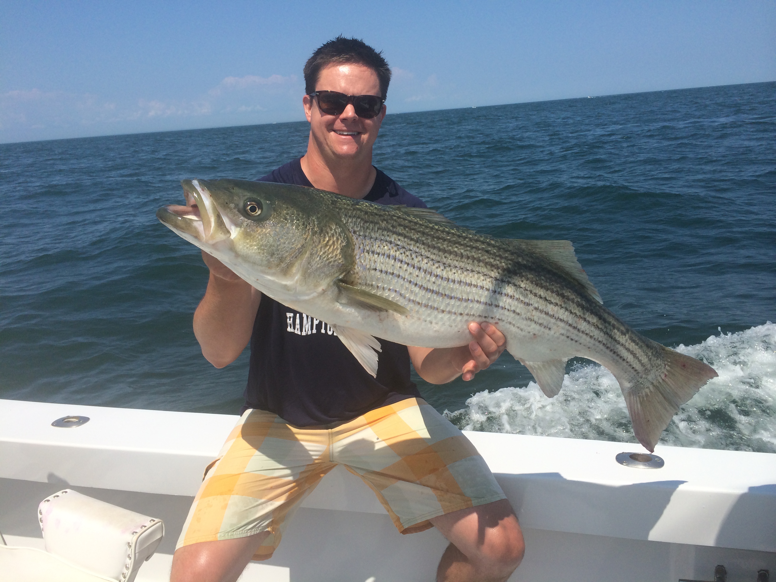 Trophy striped bass caught on a Swell Time Charter - the ultimate fishing experience