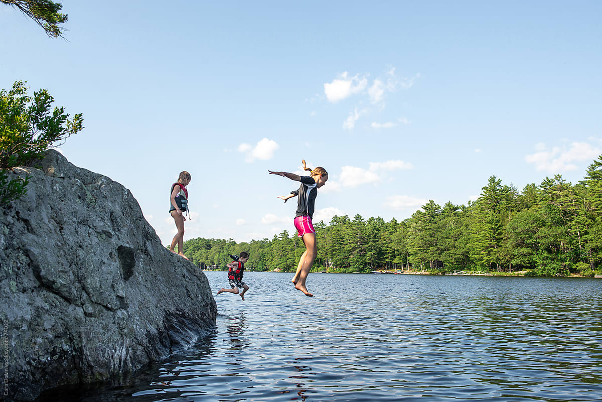Guests enjoying rock jumping into pristine Maine waters - the perfect adventure activity